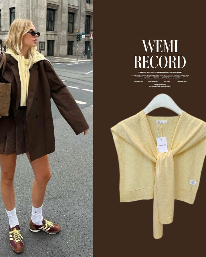 Woman walking on a street wearing a brown coat and yellow scarf, with a close-up of the yellow scarf on a hanger on the right.